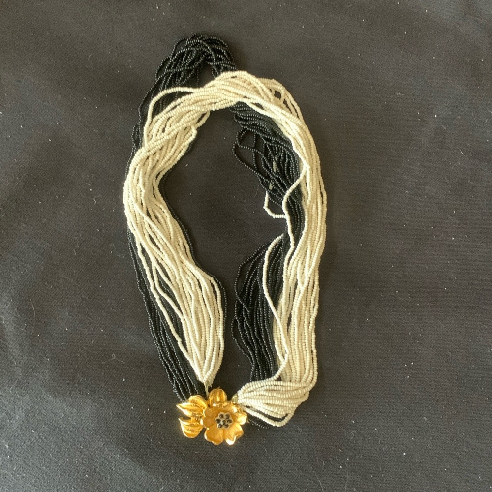 Vintage multistrand black and white beaded necklace with gold tone flower clasp